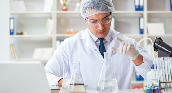 Young researcher scientist doing a water test contamination experiment in the laboratory